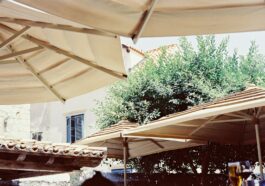 A group of tables with umbrellas on top of them